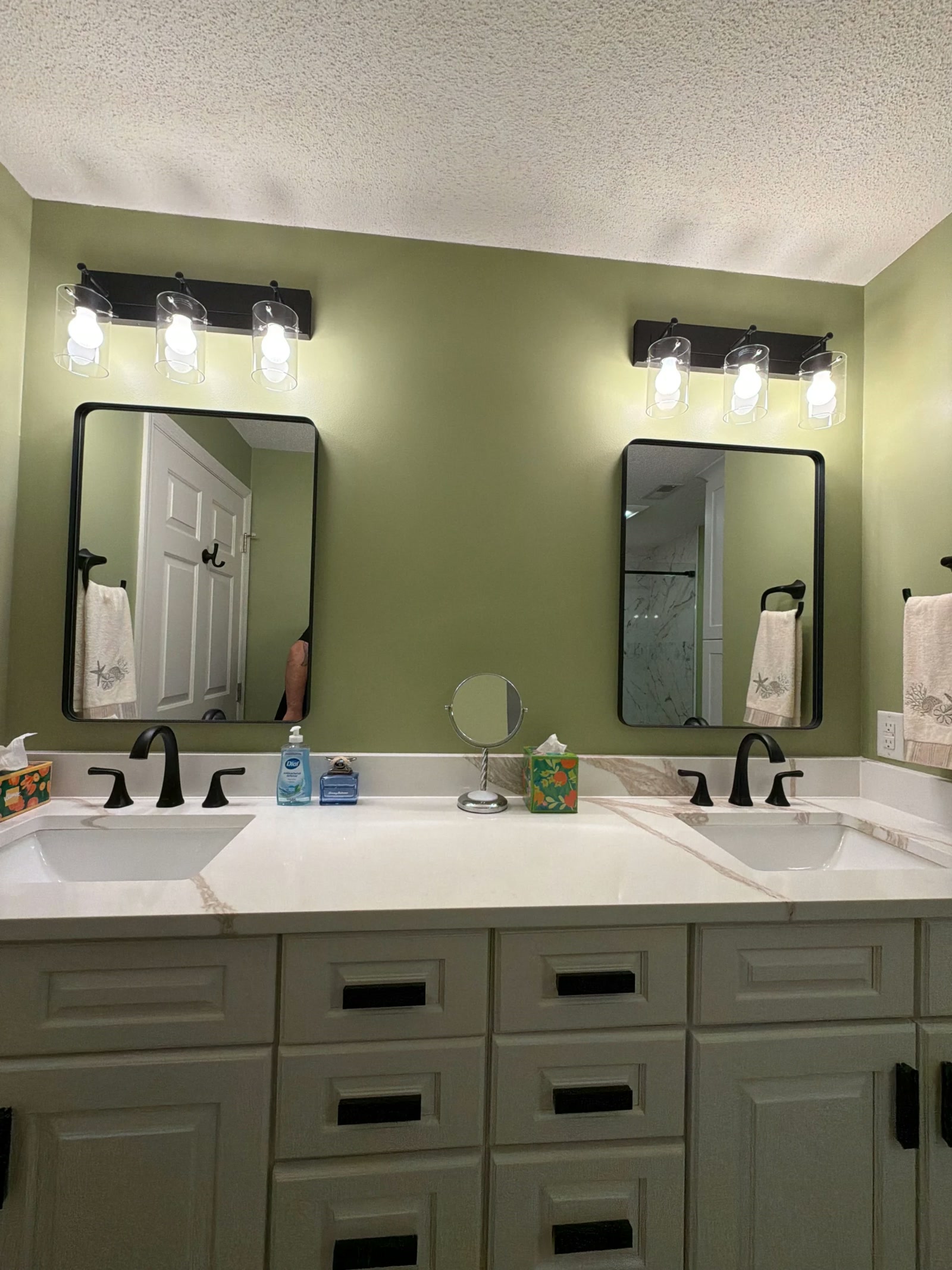 Bathroom with green wall and double vanity