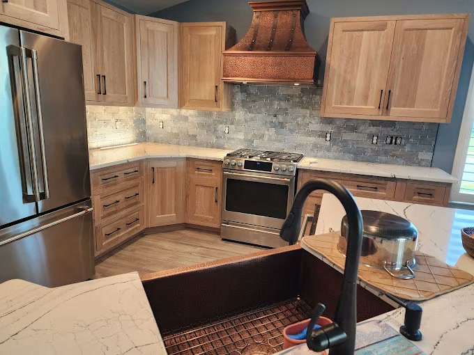 Warm kitchen with hickory cabinets and copper hood
