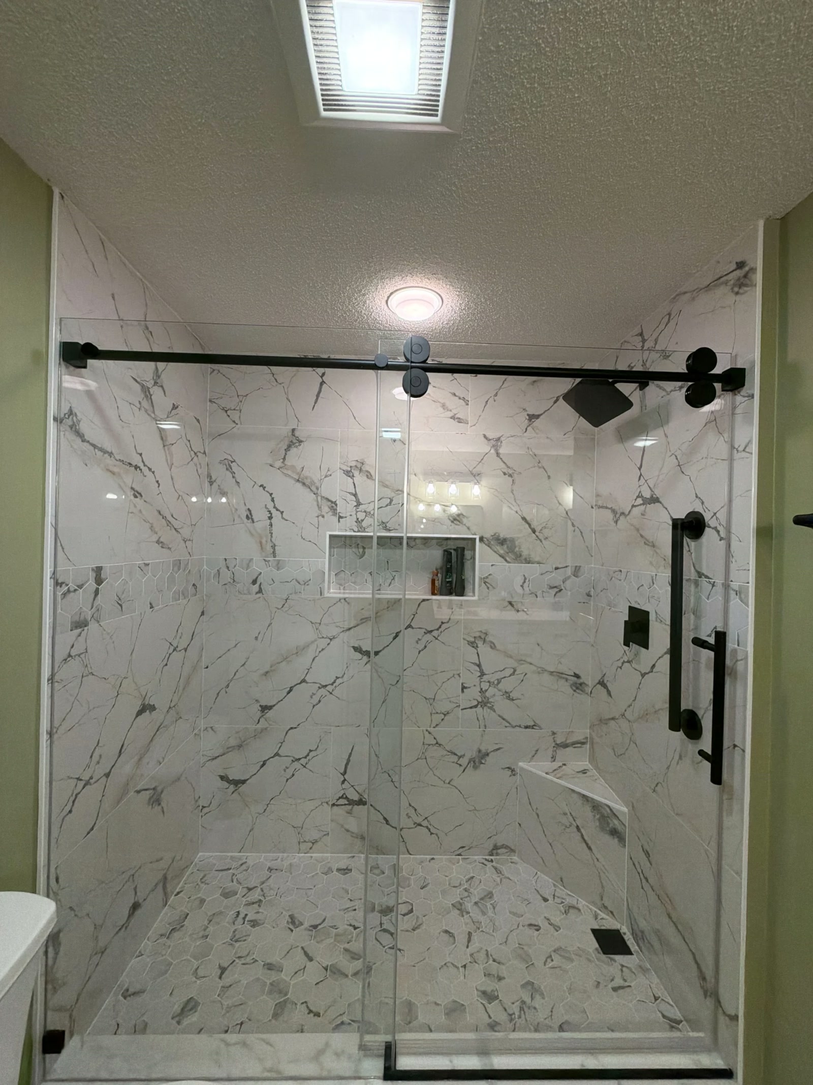 Walk in shower with marble tile